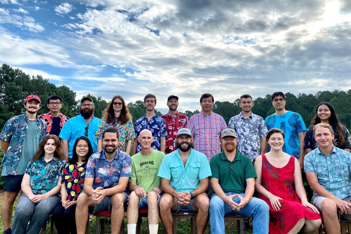 Group photo of lab members in tropical clothes at the crossing block.