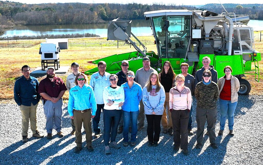 The 2025 soybean lab members, standing in front of a Wintersteiger plot combine.